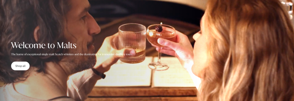 Homepage banner image from Malts.com showing a woman and man enjoying whisky together.